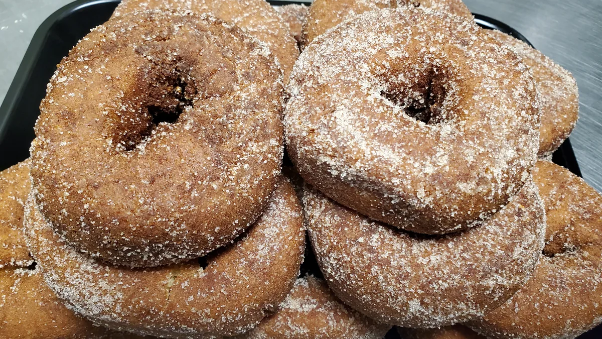 Stack of warm cinnamon-sugar apple cider donuts